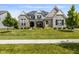 Charming two-story home featuring stone accents, a landscaped yard, and inviting front porch at 2566 Maple Creek Dr, Westfield, IN 46074