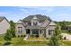 Beautiful two-story home with a well-manicured lawn and classic architectural details at 2566 Maple Creek Dr, Westfield, IN 46074