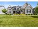 Charming two-story home featuring stone accents, a landscaped yard, and inviting front porch at 2566 Maple Creek Dr, Westfield, IN 46074