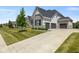 Elegant home with a three-car garage, spacious driveway, and well-kept lawn at 2566 Maple Creek Dr, Westfield, IN 46074
