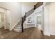 Grand foyer with wood floors, staircase, and stylish console table at 2566 Maple Creek Dr, Westfield, IN 46074