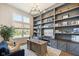 Stylish home office with large window, custom shelving, and a comfortable workspace at 2566 Maple Creek Dr, Westfield, IN 46074