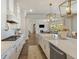 Modern white kitchen with a marble island, stainless appliances, and open layout to the living room at 2566 Maple Creek Dr, Westfield, IN 46074