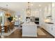 Open-concept kitchen with a large island, stainless appliances, and adjacent dining space at 2566 Maple Creek Dr, Westfield, IN 46074