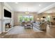 Cozy living room featuring a fireplace, large windows, and comfortable seating at 2566 Maple Creek Dr, Westfield, IN 46074