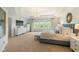 Bright main bedroom with tray ceiling, chandelier, large windows and designer touches at 2566 Maple Creek Dr, Westfield, IN 46074