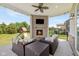 Inviting covered patio with a fireplace and cozy seating area, offering a great view of the backyard at 2566 Maple Creek Dr, Westfield, IN 46074