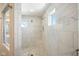 The elegant shower has white tile, two shower heads, a window, and a built-in seat at 2566 Maple Creek Dr, Westfield, IN 46074
