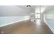 Spacious attic features wood floor, light blue walls, and a bright window letting in natural light at 2627 Chase St, Anderson, IN 46016