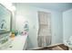 The bathroom features a vanity, patterned shower curtain, and standard toilet at 2627 Chase St, Anderson, IN 46016