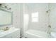 Bathroom with tiled shower and tub combination, updated vanity, and natural light at 2627 Chase St, Anderson, IN 46016