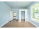 Bedroom with hardwood floors, built-in closet, and a large window at 2627 Chase St, Anderson, IN 46016