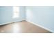 Bedroom with hardwood floors and natural light from a large window at 2627 Chase St, Anderson, IN 46016