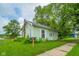 Charming two-story home with light green siding, green foliage, and a well-manicured lawn at 2627 Chase St, Anderson, IN 46016