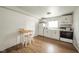 The kitchen features a wood floor, white appliances, and a white table with stools at 2627 Chase St, Anderson, IN 46016