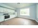 Bright kitchen featuring white appliances, cabinetry, and natural light at 2627 Chase St, Anderson, IN 46016