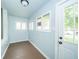 Bright mud room with hardwood floors and access to the outside at 2627 Chase St, Anderson, IN 46016
