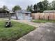 View of the backyard with a small outbuilding and a combination of concrete and grass landscaping at 2731 Delaware St, Anderson, IN 46016