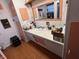 Cozy bathroom featuring an extended vanity, peach accents, and a spacious mirror at 2731 Delaware St, Anderson, IN 46016