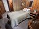 Cozy bedroom with a twin bed, nightstand, and wall mirror at 2731 Delaware St, Anderson, IN 46016