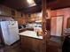 Classic kitchen featuring an island, white fridge, and ample cabinet storage at 2731 Delaware St, Anderson, IN 46016