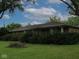 Single-story brick home with well-maintained landscaping and a beautiful yard at 3103 Westenedge Dr, Columbus, IN 47203