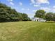 Large backyard with grass and trees at 32 W Northeast Ct, Shelbyville, IN 46176