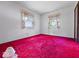 Bedroom with red carpet, white walls and two windows with light-colored curtains at 32 W Northeast Ct, Shelbyville, IN 46176
