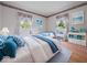 Bright, cheerful bedroom with matching beds, curtains, and beach-themed decorations at 32 W Northeast Ct, Shelbyville, IN 46176