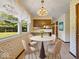 Bright breakfast nook features a round table, four chairs, and large windows overlooking the outdoors at 32 W Northeast Ct, Shelbyville, IN 46176