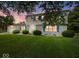 Two-story home with blue shutters, under a pink sunset sky, highlighting suburban charm at 32 W Northeast Ct, Shelbyville, IN 46176