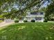 Charming two-story home boasts blue shutters and a well-manicured lawn, creating a welcoming curb appeal at 32 W Northeast Ct, Shelbyville, IN 46176