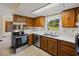 Bright kitchen with stainless steel appliances, wood cabinets, and a window over the sink at 32 W Northeast Ct, Shelbyville, IN 46176