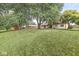 Large backyard with mature trees, perfect for outdoor activities and relaxation at 3224 Prague Rd, Indianapolis, IN 46227