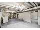 Spacious basement area with painted floors and exposed ductwork, and includes a laundry area at 3224 Prague Rd, Indianapolis, IN 46227