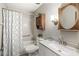 Well-lit bathroom featuring a vanity with solid surface top and a tub with tiled surround at 3224 Prague Rd, Indianapolis, IN 46227