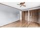 Spacious bedroom featuring beautiful hardwood floors, neutral paint and a classic ceiling fan at 3224 Prague Rd, Indianapolis, IN 46227