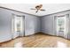 Bright and airy bedroom featuring hardwood floors, natural light, and a classic ceiling fan at 3224 Prague Rd, Indianapolis, IN 46227
