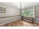 Bright dining room featuring hardwood floors, a chandelier, and a large window with views of the outdoors at 3224 Prague Rd, Indianapolis, IN 46227