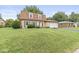 Charming brick home featuring a well-maintained lawn and two-car attached garage at 3224 Prague Rd, Indianapolis, IN 46227