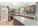 Stylish kitchen with wooden cabinets, granite countertops, stainless appliances, and center island at 3224 Prague Rd, Indianapolis, IN 46227