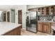 Well-equipped kitchen with stainless steel refrigerator, speckled granite countertops and wooden cabinets at 3224 Prague Rd, Indianapolis, IN 46227