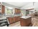 Bright kitchen boasts stainless appliances, granite counters, and access to the backyard at 3224 Prague Rd, Indianapolis, IN 46227