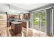 Modern kitchen with an island, stainless steel appliances, and sliding glass door to outside at 3224 Prague Rd, Indianapolis, IN 46227