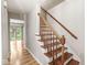 Classic wooden staircase leading to the upper level of the home with neutral wall color and bright lighting at 3224 Prague Rd, Indianapolis, IN 46227