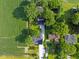 Birds-eye view of a home on a sprawling lot, bordered by lush greenery and a nearby cornfield at 3777 W State Road 234, McCordsville, IN 46055