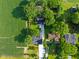 Birds-eye view of a home on a sprawling lot, bordered by lush greenery and a nearby cornfield at 3777 W State Road 234, McCordsville, IN 46055