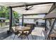 Inviting covered back deck with ceiling fan, outdoor dining area, and hot tub for relaxing and entertaining at 3777 W State Road 234, McCordsville, IN 46055
