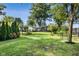 Large private backyard with mature trees, pergola, back deck, and landscaping at 3777 W State Road 234, McCordsville, IN 46055