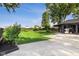 Expansive backyard featuring lush lawn, garden area, concrete patio, and detached garage/shed at 3777 W State Road 234, McCordsville, IN 46055